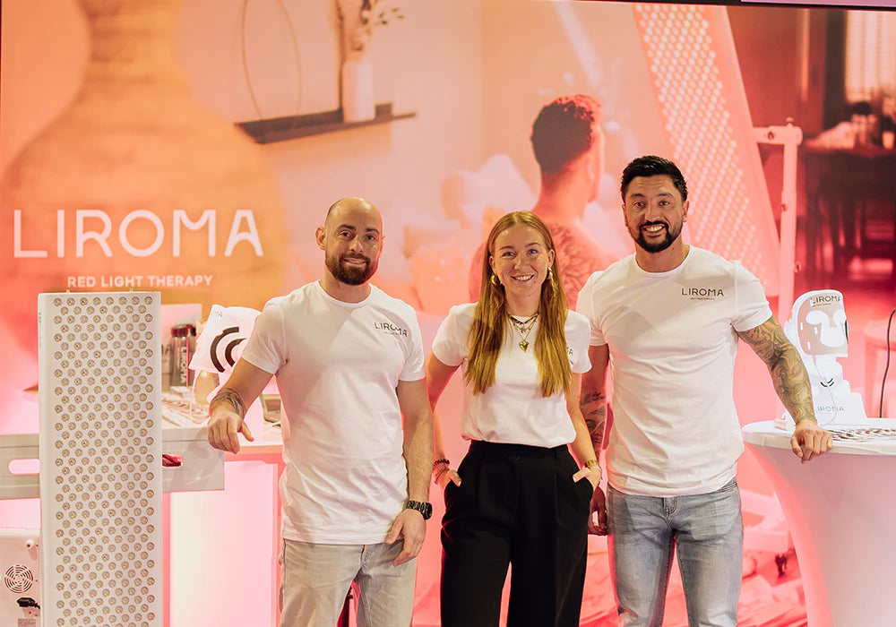 El equipo de Liroma en su stand con un panel de luz roja